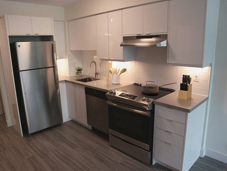 Renovated Kitchen with Stainless Steel Appliances and White Cabinets